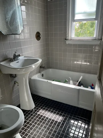 a view of a kitchen with a stove fridge and wooden floor