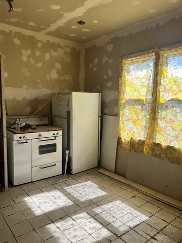 a bathroom with shower and window