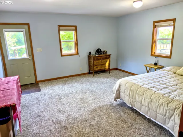 a bathroom with a granite countertop sink toilet and mirror