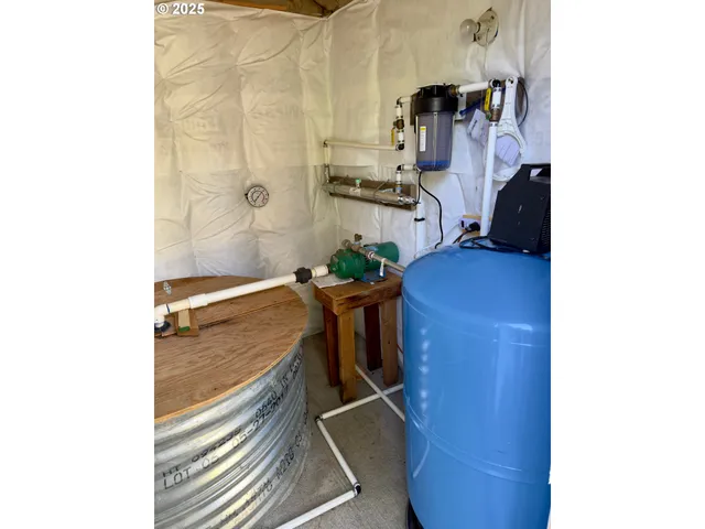 a bed sitting in a bedroom next to a mirror