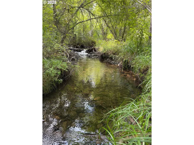 a view of a swimming pool with an outdoor seating and a yard