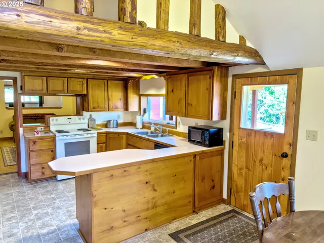 a kitchen with stainless steel appliances kitchen island granite countertop a sink and cabinets