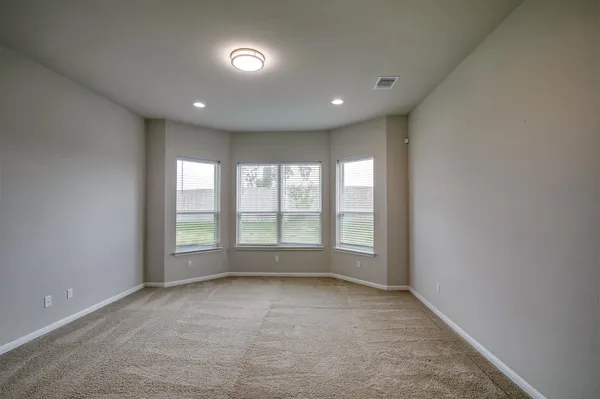 an empty room with large windows