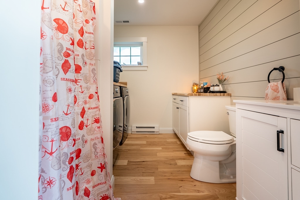 24 Coury Drive Acushnet, MA 02743 - Photo 13 of 42 a bathroom with a toilet and a shower curtain