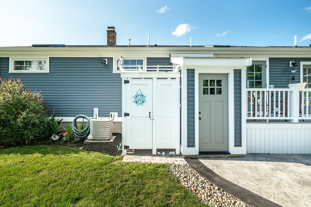 24 Coury Drive Acushnet, MA 02743 - Photo 31 of 42 a view of a patio with table and chairs and potted plants