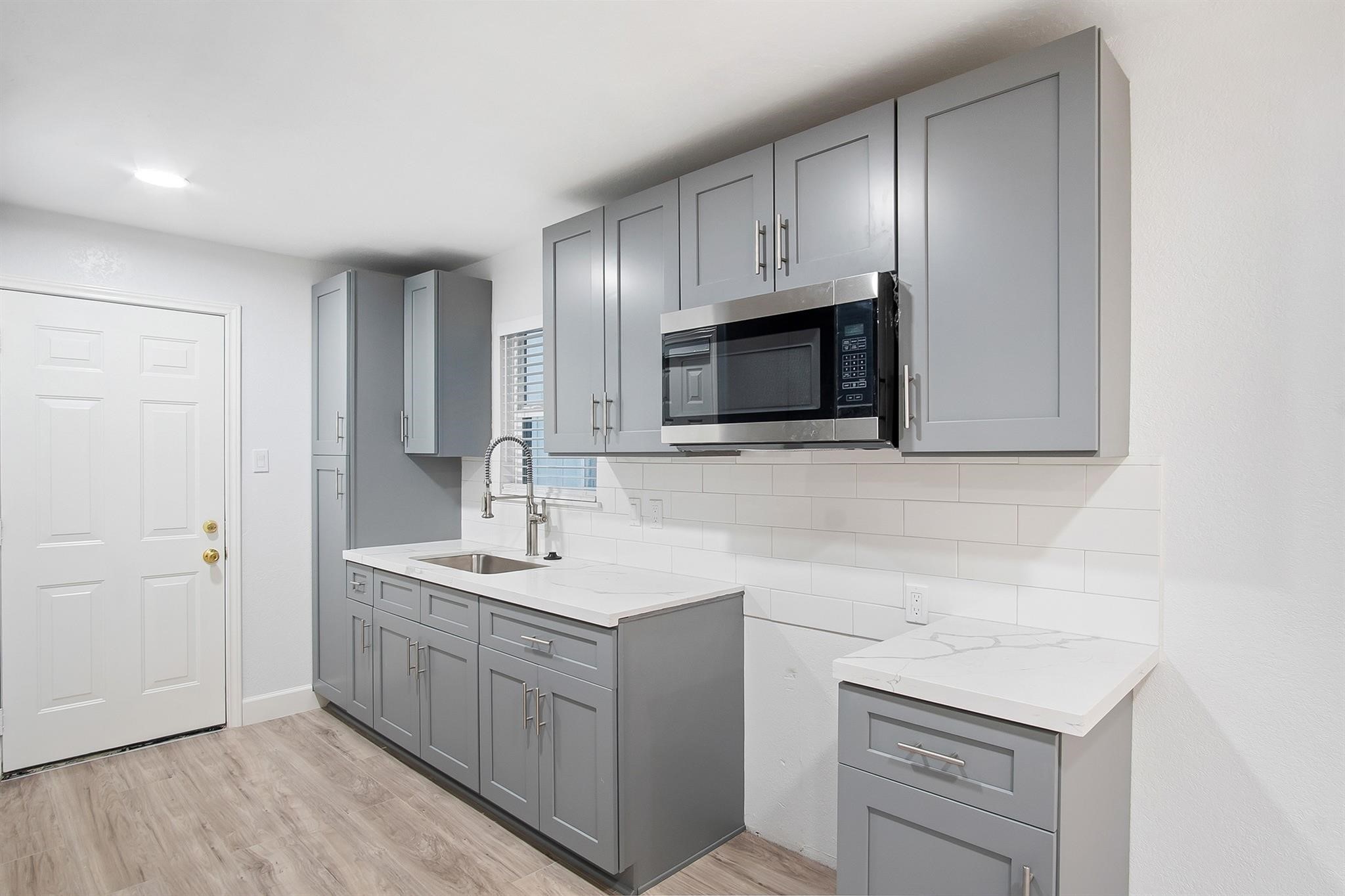 4808 Terry Street Houston, TX 77009 - Photo 11 of 21 a kitchen with a sink cabinets and microwave