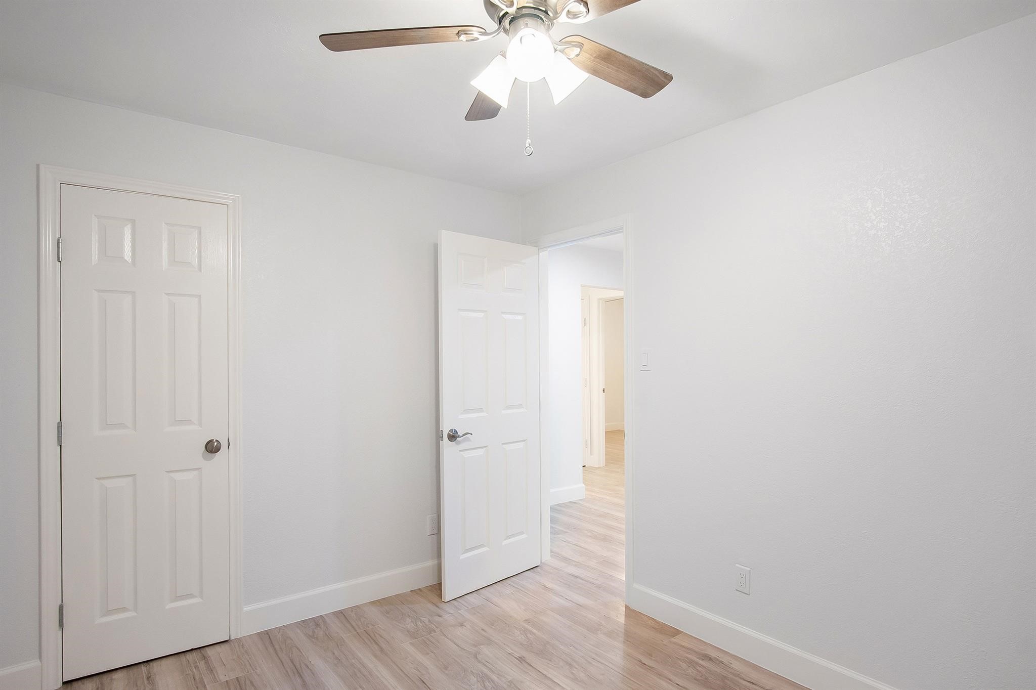 4808 Terry Street Houston, TX 77009 - Photo 14 of 21 an empty room with wooden floor closet and windows