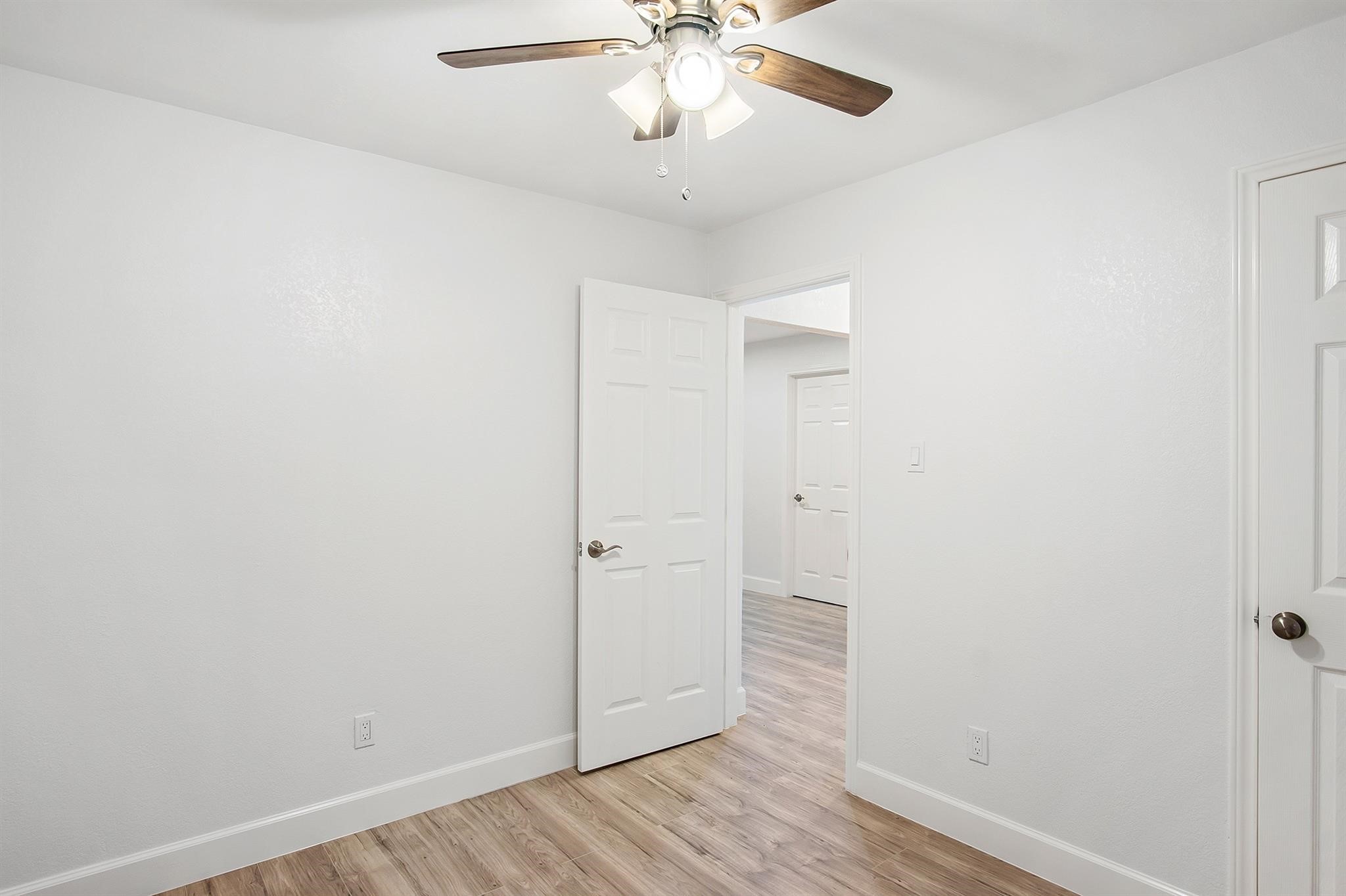4808 Terry Street Houston, TX 77009 - Photo 17 of 21 an empty room with wooden floor and ceiling fan