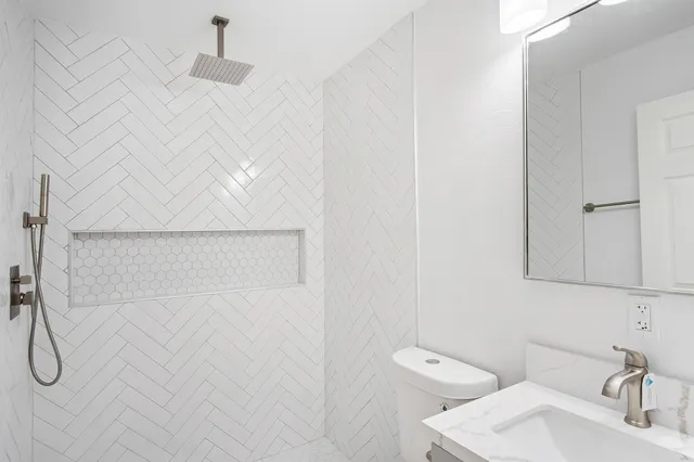 a view of a room with a ceiling fan and a window