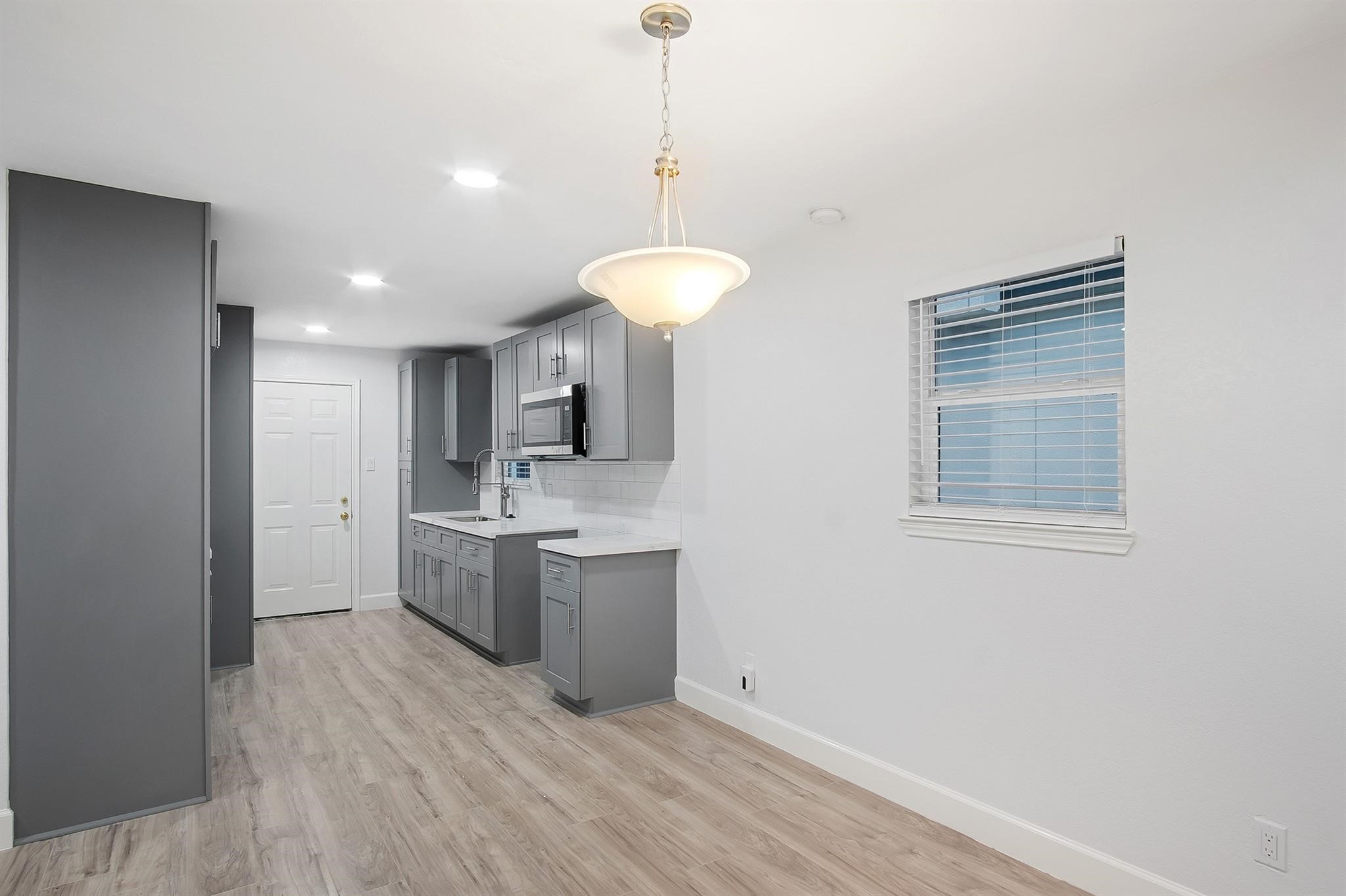 4808 Terry Street Houston, TX 77009 - Photo 8 of 21 a kitchen with kitchen island a sink stainless steel appliances and cabinets