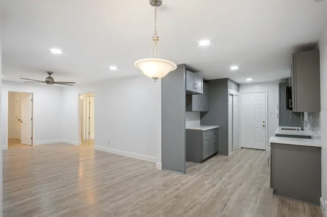a kitchen with granite countertop a sink stove and refrigerator