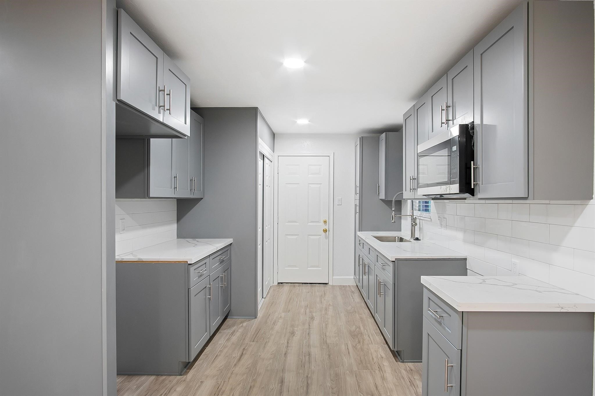 4808 Terry Street Houston, TX 77009 - Photo 10 of 21 a kitchen with granite countertop a sink stove and refrigerator