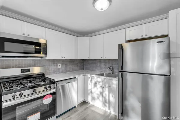 a kitchen with a refrigerator stove and microwave