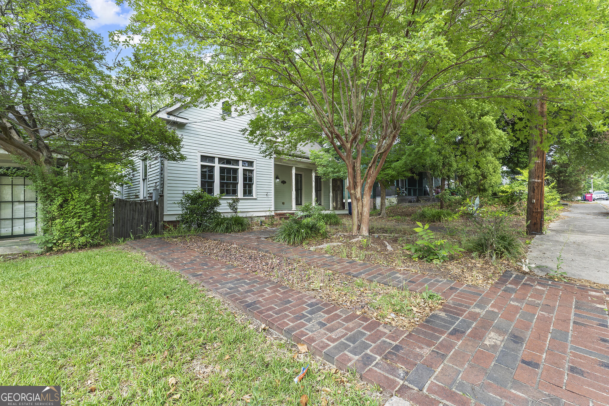 1469 Chestnut Street Macon, GA 31201 - Photo 2 of 26 a front view of a house with a garden
