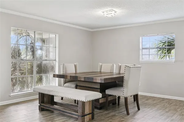 a dining room with furniture and wooden floor