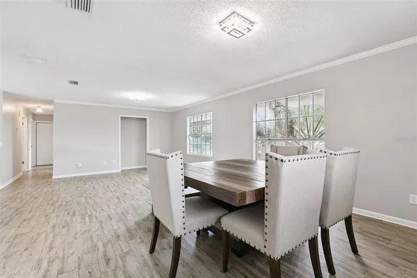 a kitchen with a refrigerator stove and wooden floor