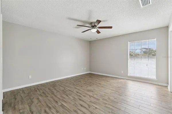 a view of a workspace with furniture and wooden floor