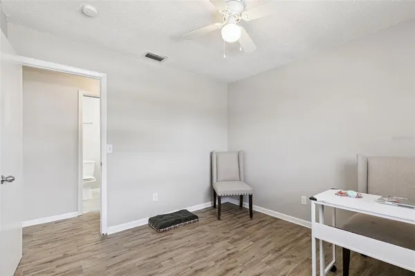 a view of a workspace with furniture and wooden floor