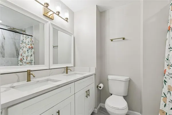 a bathroom with a toilet and shower curtain