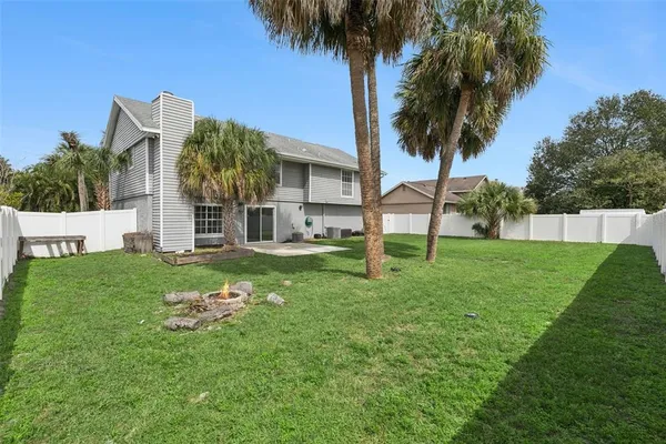 a view of backyard with swimming pool and green space