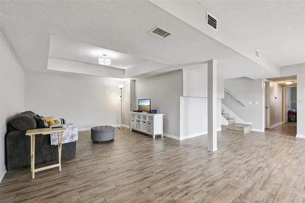 an empty room with wooden floor and fireplace