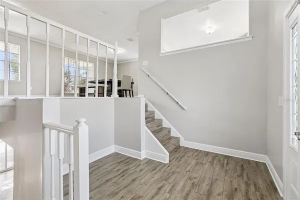 a living room with a wooden floor and furniture