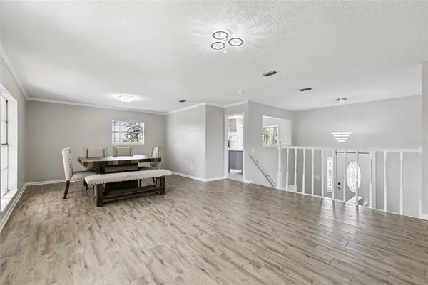 a living room with furniture a table and a large window
