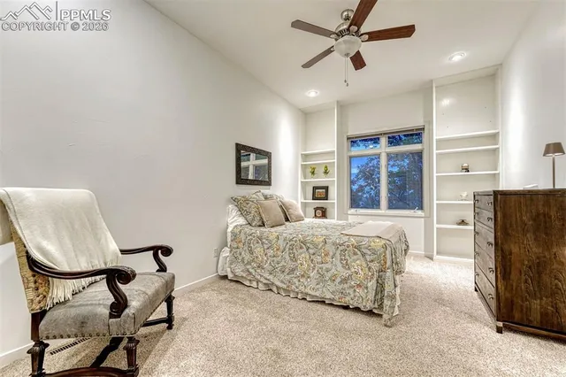 a bedroom with a bed and a large mirror