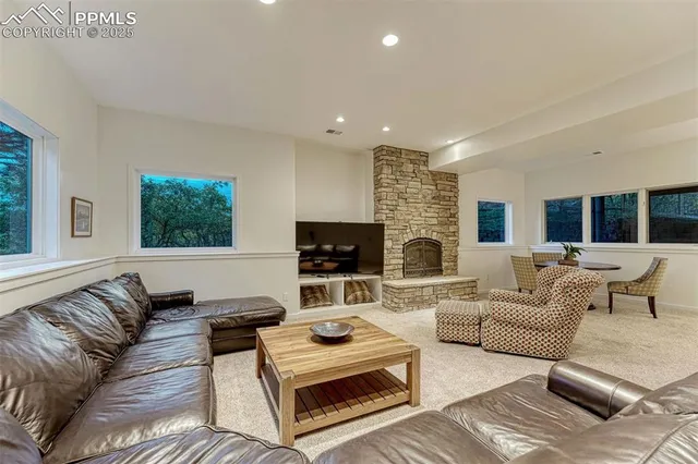 a living room with furniture and a kitchen