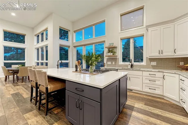 a roof deck with couches and wooden floor