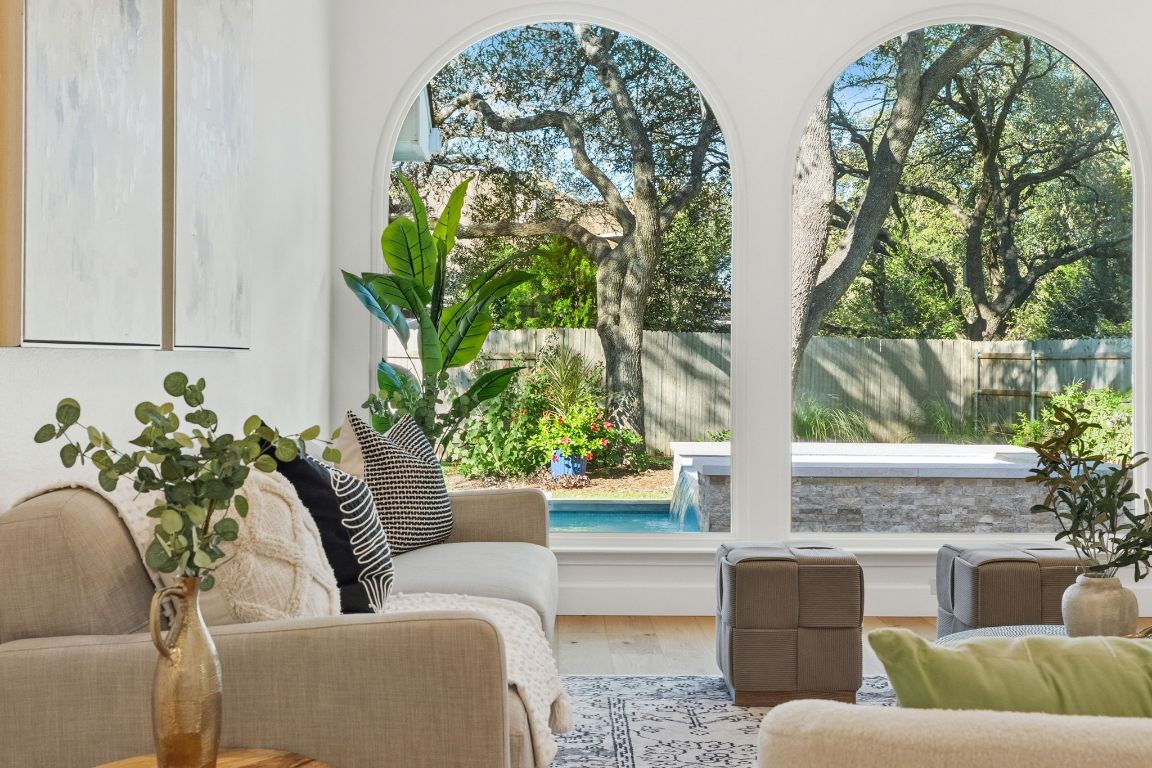 a living room with couches and a potted plant
