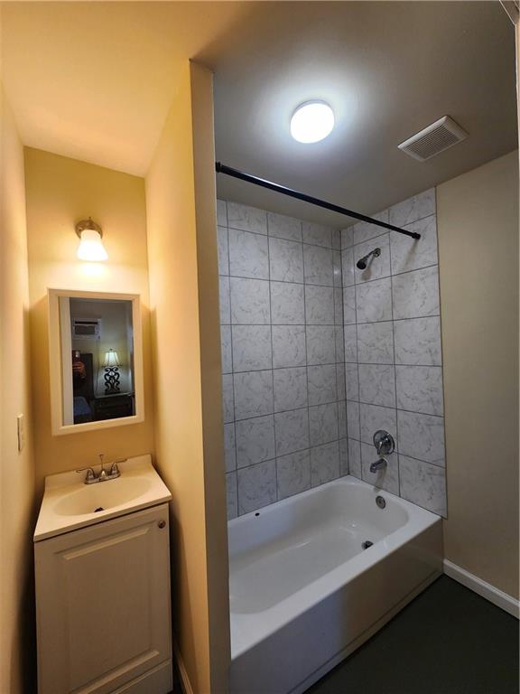 1470 St Michael Avenue, Unit 2 Atlanta, GA 30344 - Photo 11 of 23 a bathroom with a tub a sink and mirror