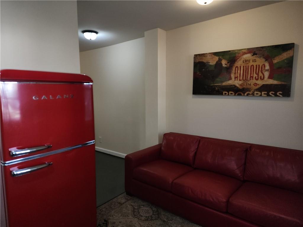 1470 St Michael Avenue, Unit 2 Atlanta, GA 30344 - Photo 17 of 23 a blue couch sitting in a living room with a lamp