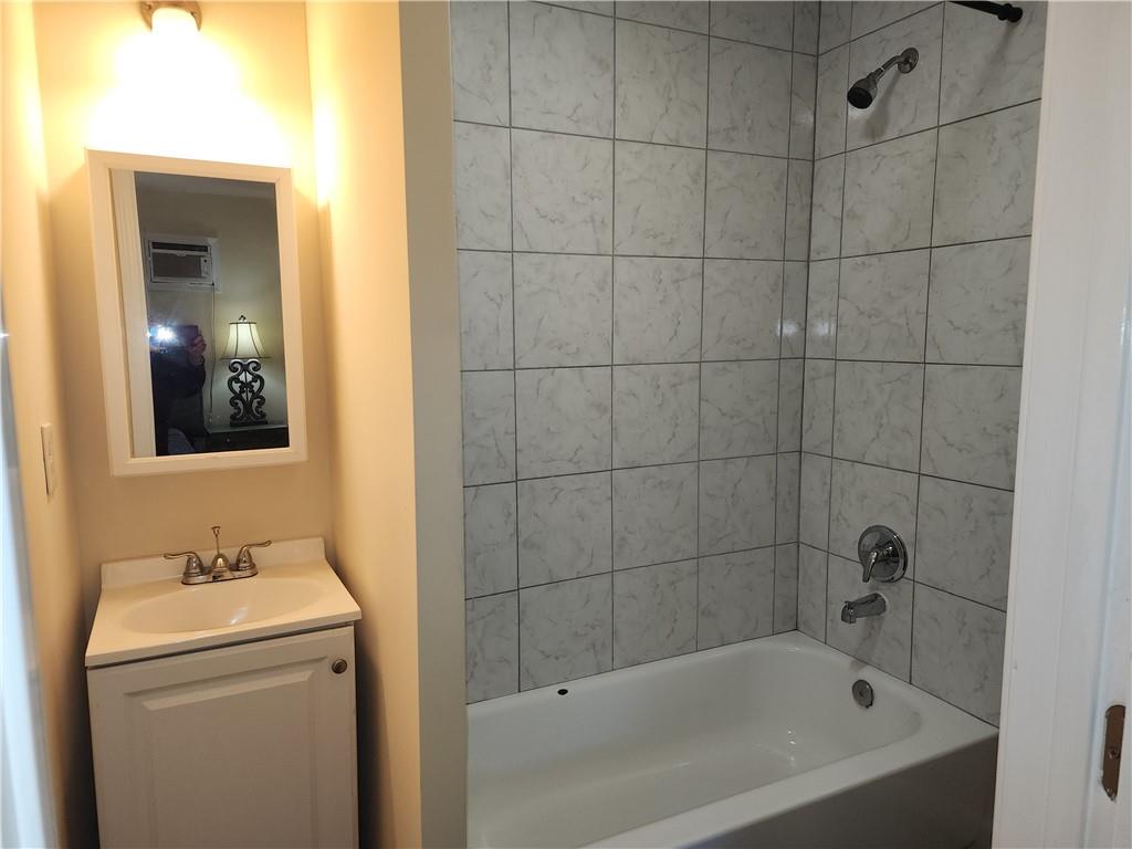 1470 St Michael Avenue, Unit 2 Atlanta, GA 30344 - Photo 20 of 23 a bathroom with a sink and mirror with bathtub