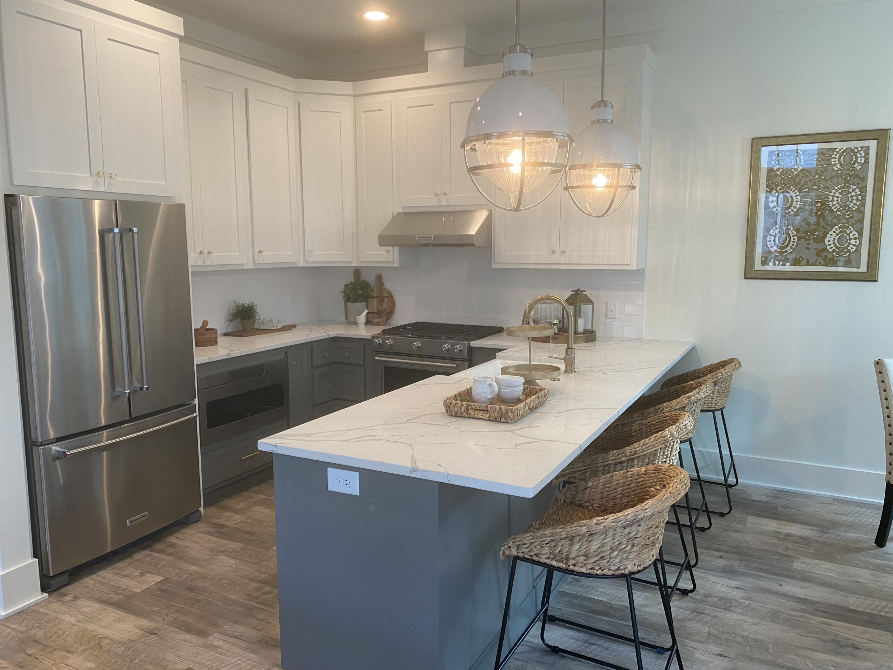 8 Lazy Day Ln Inlet Beach Inlet Beach, FL 32461 - Photo 9 of 13 a kitchen with stainless steel appliances a table chairs and a refrigerator
