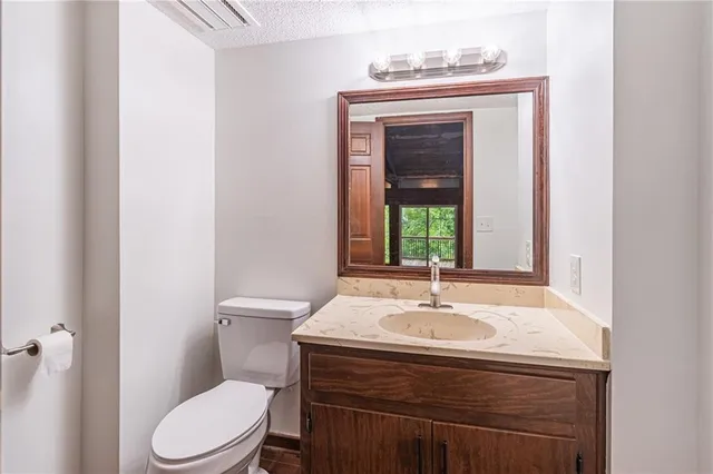 a bathroom with a sink a toilet and mirror