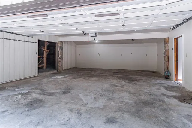 a large kitchen with stainless steel appliances a large counter top a stove and a refrigerator