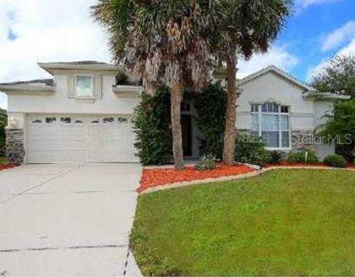 a front view of a house with yard and garage