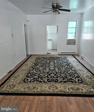 a view of a room with wooden floor and staircase