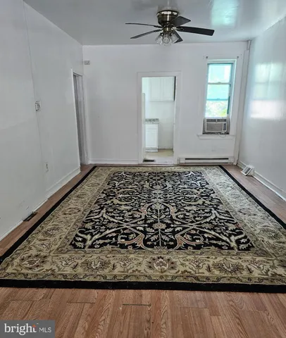 a view of a room with wooden floor and staircase