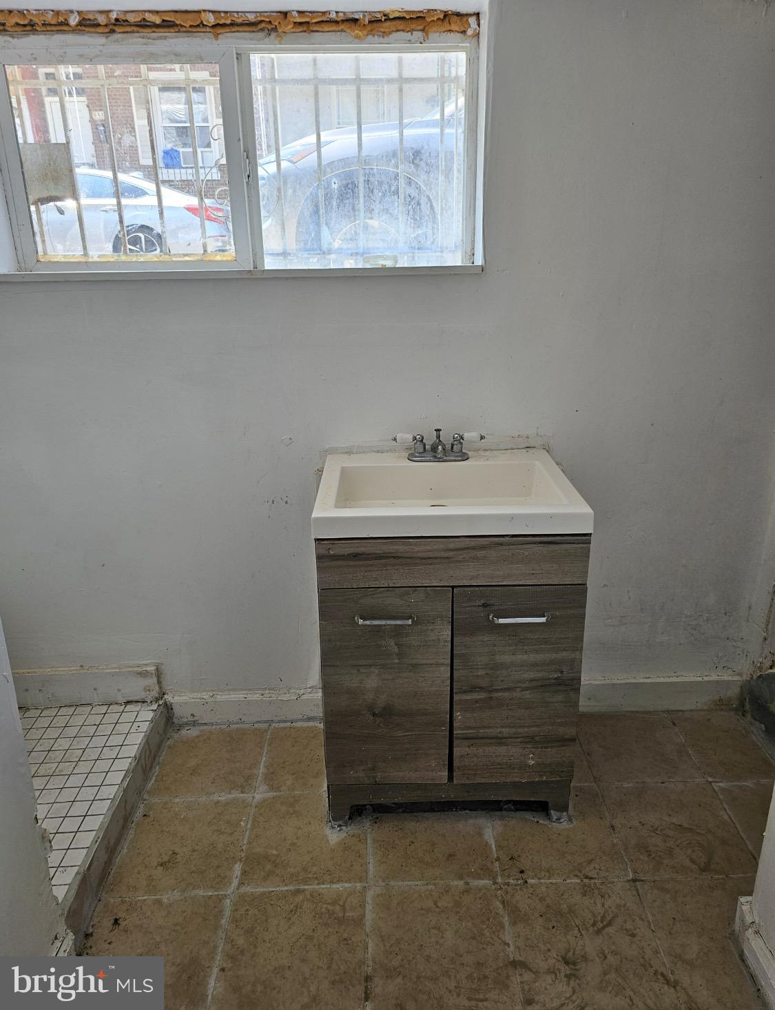 4533 North Hicks Street, Unit 1 Philadelphia, PA 19140 - Photo 2 of 2 a bathroom with a sink and a mirror