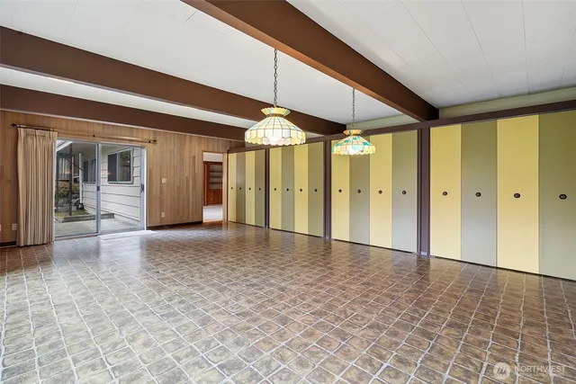 a view of a hallway with wooden shelves