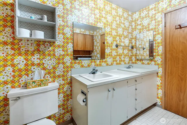 a bathroom with a sink toilet vanity and shower