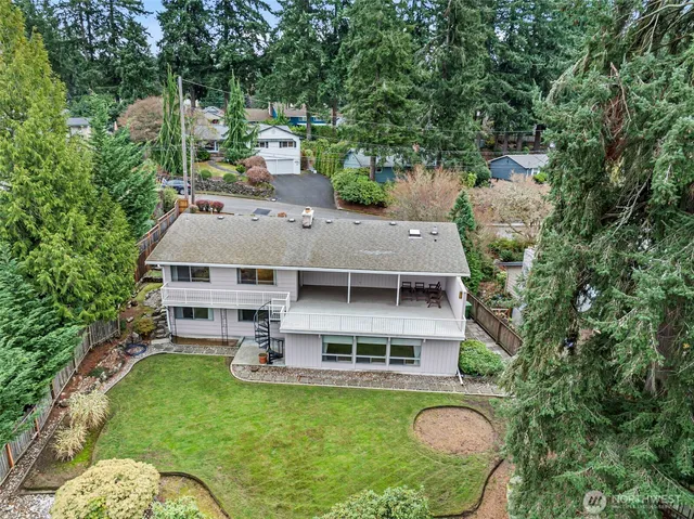 an aerial view of a house with swimming pool garden and patio
