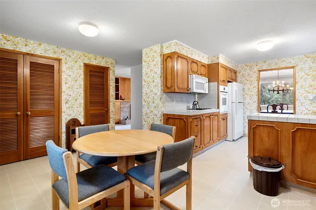 a view of a dining room with furniture and a potted plant