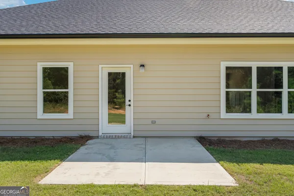 a view of a brick house with a yard