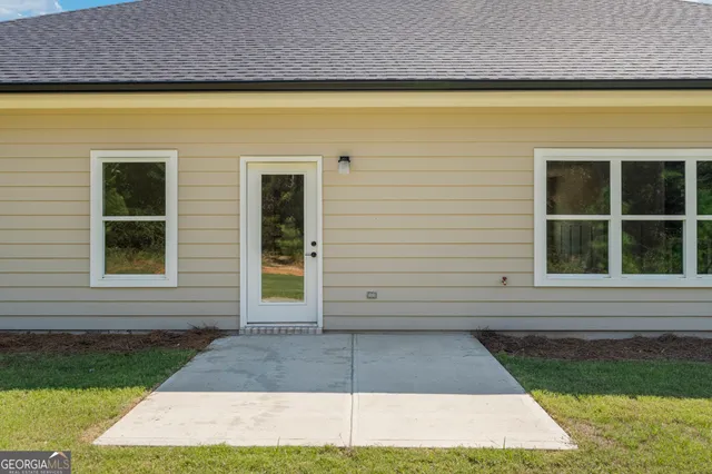 a view of a brick house with a yard