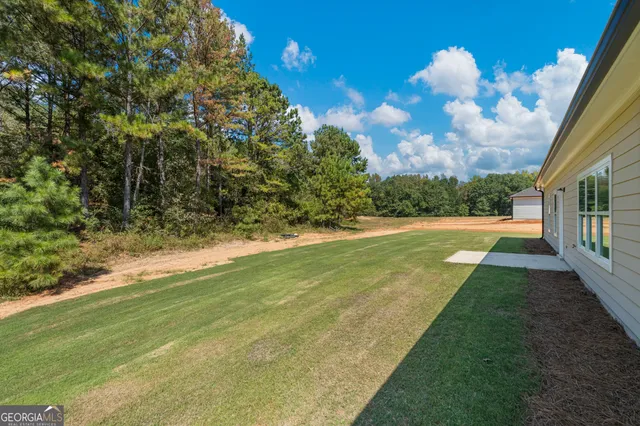 a view of yard with swimming pool and green space