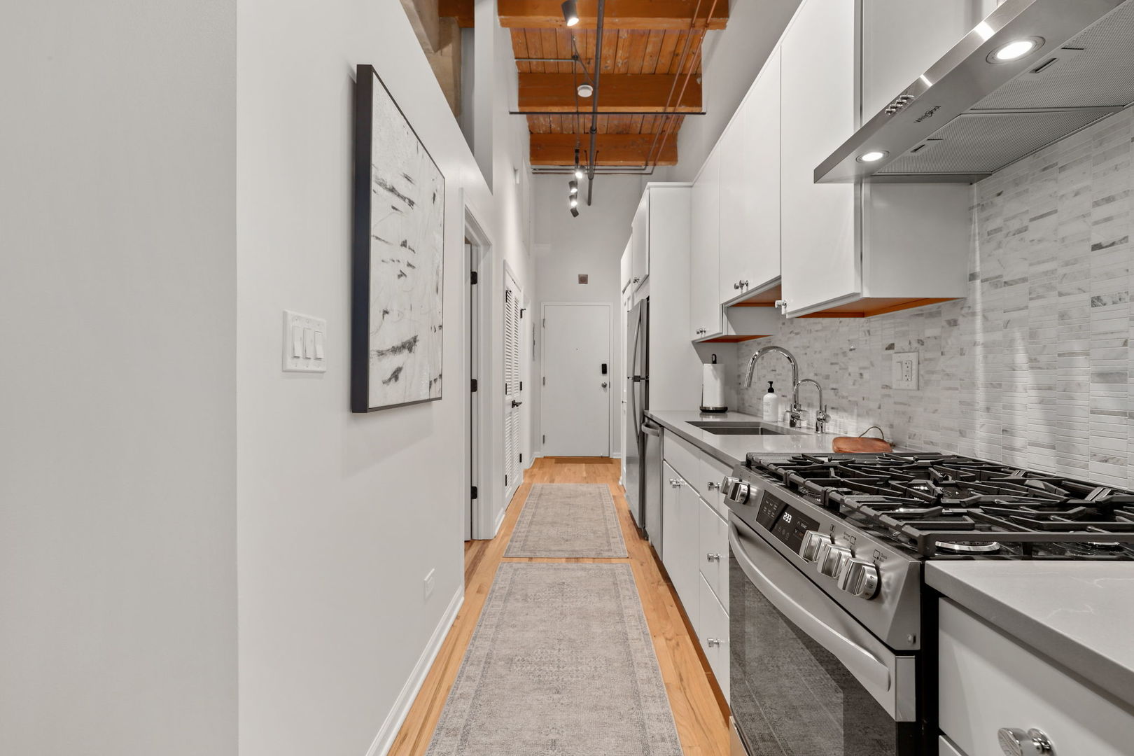 215 North Aberdeen Street, Unit 202B Chicago, IL 60607 - Photo 12 of 19 a kitchen with stainless steel appliances granite countertop a stove and a shower