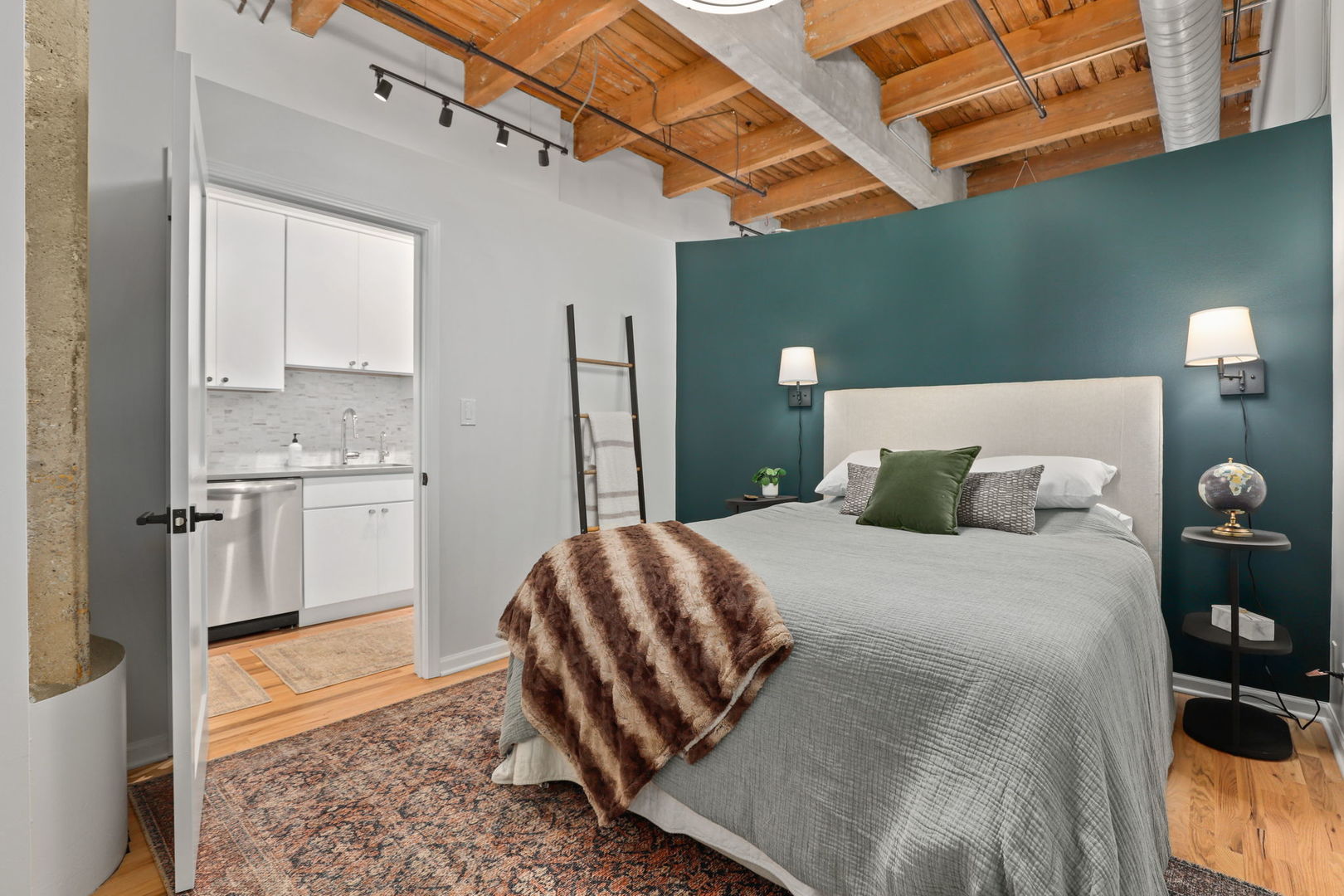 215 North Aberdeen Street, Unit 202B Chicago, IL 60607 - Photo 13 of 19 a bedroom with a bed and cabinets